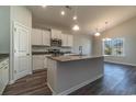 Modern kitchen with white cabinets, granite countertops, and stainless steel appliances at 403 Lifestyle Court, Surfside Beach, SC 29575