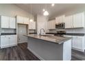 Modern kitchen with island, white cabinets, and granite countertops at 403 Lifestyle Court, Surfside Beach, SC 29575