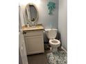 Small bathroom with granite countertop, white vanity, and teal accents at 4714 Woodland St., North Myrtle Beach, SC 29582