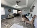 Open-concept living room with coastal decor, a dining table, and wood-look flooring for a relaxing ambiance at 4714 Woodland St., North Myrtle Beach, SC 29582