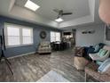 Inviting living area with ample natural light, comfortable seating, a dining table, and a partial kitchen view at 4714 Woodland St., North Myrtle Beach, SC 29582