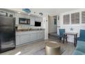 Condo kitchen with gray cabinets, black appliances, and beach decor at 4800 S Ocean Blvd. # 710, North Myrtle Beach, SC 29582