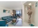 Bright living room with ocean views, teal sofa, and coastal decor at 4800 S Ocean Blvd. # 710, North Myrtle Beach, SC 29582