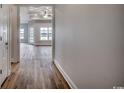 Hallway with wood-look floors, offering views to the living room at 4983 Dupont Rd., Conway, SC 29526