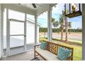 Screened porch with wooden bench, offering peaceful views at 512 Ayrhill Loop, Myrtle Beach, SC 29588