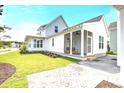 Home exterior showcasing white siding and a brick patio at 512 Ayrhill Loop, Myrtle Beach, SC 29588