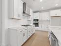 Modern kitchen with white cabinets, stainless steel appliances, gas cooktop, and sleek countertops at 540 Ayrhill Loop, Myrtle Beach, SC 29588