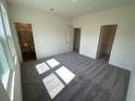 Bright bedroom with gray carpet, large windows, and an ensuite bathroom at 627 Muster Field Ct., Conway, SC 29526