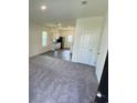 Open living room with gray carpet, kitchen, and access to backyard at 627 Muster Field Ct., Conway, SC 29526