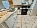White kitchen cabinets, black appliances, and tile floor at 636 Waterway Village Blvd. # 17C, Myrtle Beach, SC 29579