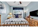 Bedroom with a wooden bed frame, window with blinds, and a dresser at 834 Arezzo Way # 834, Myrtle Beach, SC 29579