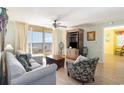 Bright living room with balcony access offering views of the ocean at 8560 Queensway Blvd. # 1210, Myrtle Beach, SC 29572