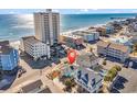 Aerial view showing beach house location near ocean and other homes at 923 N Waccamaw Dr., Garden City Beach, SC 29576