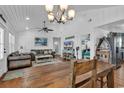 Bright dining room with rustic wooden table and white walls at 923 N Waccamaw Dr., Garden City Beach, SC 29576