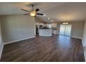 Open living space with hardwood floors, kitchen island, and access to backyard at Tbd9 Casey Dr., Green Sea, SC 29545