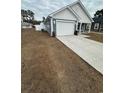 Gray siding, white trim, two-car garage, and a large driveway at 1028 Seaside Dr., North Myrtle Beach, SC 29582