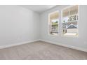 Minimalist bedroom features plush carpeting, neutral walls, and double windows for ample natural light at 1099 Nw Forest Bend Dr., Calabash, NC 28467