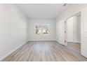 Bright, airy bedroom with wood-look flooring, a window, and a doorway leading to another room at 1336 Winding Creek Way, Myrtle Beach, SC 29588