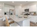 Modern kitchen with white cabinets, granite countertops, and stainless steel appliances at 1439 Porchfield Dr., Conway, SC 29526