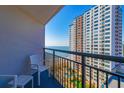 Balcony view features chairs overlooking the ocean with a view of the neighbor hotel at 1501 S Ocean Blvd. S # 1450, Myrtle Beach, SC 29577