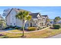 Side view of the building showcasing its architectural style and landscaping at 1870 Auburn Ln. # 21J, Surfside Beach, SC 29575