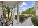 Front porch with bench and palm trees, leads to walkway at 202 Junco Circle, Longs, SC 29568