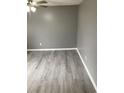 A freshly painted bedroom boasts neutral colors, updated gray vinyl flooring, and modern lighting fixtures at 206 W Pine St., Johnsonville, SC 29555