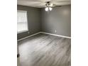 Spacious bedroom with gray walls, wood-look flooring, and ceiling fan at 206 W Pine St., Johnsonville, SC 29555