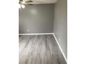 Bright living room with gray walls, wood-look flooring, and ceiling fan at 206 W Pine St., Johnsonville, SC 29555