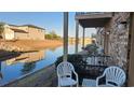 Patio with white chairs overlooking a calm lake at 210 Double Eagle Dr. # H-1, Surfside Beach, SC 29575