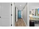Clean and bright condo hallway with blue door at 2301 S Ocean Blvd. # 1101, North Myrtle Beach, SC 29582