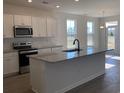 Modern kitchen with white cabinets, stainless steel appliances, and a granite island at 243 Letha Dr, Longs, SC 29568