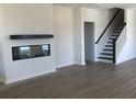 Cozy living room features a fireplace and wooden mantle, complemented by nearby staircase at 243 Letha Dr, Longs, SC 29568