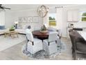 Open concept dining area with a round table and seating for six at 2604 Watershed Way, Longs, SC 29568
