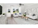 Bright living room featuring light walls, comfy sofas, and a striped rug at 2604 Watershed Way, Longs, SC 29568