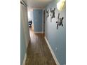 Inviting hallway features wood-look flooring and stylish turtle wall decor leading into the condo at 2701 S. Ocean B S Ocean Blvd. # 508, North Myrtle Beach, SC 29582