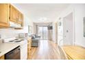 Small condo kitchen with light wood cabinets and appliances at 2710 S Ocean Blvd. # 207 A, Myrtle Beach, SC 29577