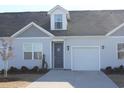 Gray siding two-story home with blue door and attached garage at 3528 Bells Lake Circle # 220, Longs, SC 29568