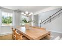 Dining area with light wood table and chairs, view to kitchen and staircase at 400 Clear Lake Dr., Conway, SC 29526
