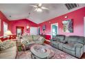 Cozy living room with plush sofas, area rug, vaulted ceiling, and bright accent wall at 403 20Th Ave. N, North Myrtle Beach, SC 29582
