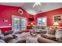 Well-lit living space with a vaulted ceiling, stylish decor, and access to the outdoors at 403 20Th Ave. N, North Myrtle Beach, SC 29582