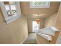 Beautifully decorated staircase featuring modern wall texture, natural light, and neutral colors at 4440 Lady Banks Ln. # 10H, Murrells Inlet, SC 29576