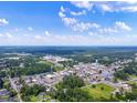 Aerial view of a town, showing its layout, buildings, and surrounding landscape at 467 Ribbon Rail Way, Loris, SC 29569