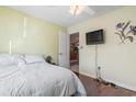 Bright bedroom with hardwood floors, a ceiling fan, and a mounted television at 461 Spauldingwood Rd., Little River, SC 29566