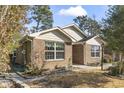 This brick house has green and dead foliage framing the home at 461 Spauldingwood Rd., Little River, SC 29566