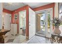 Inviting foyer with tile flooring, leads to rooms with hardwood floors and bright natural light at 461 Spauldingwood Rd., Little River, SC 29566