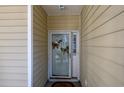Condo entrance with glass door and butterfly decor at 5090 Windsor Green Way # 104, Myrtle Beach, SC 29579