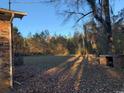 View of brick house backyard, showing open space, trees and brick structure at 5944 Rose Hill Rd., Georgetown, SC 29440