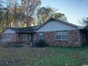 View of exterior of brick house, showing lawn, shade trees and entry doorway at 5944 Rose Hill Rd., Georgetown, SC 29440