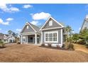 A view of the exterior highlighting the siding, windows, roofline, and outdoor covered patio space at 5960 Bolsena Place, Myrtle Beach, SC 29577